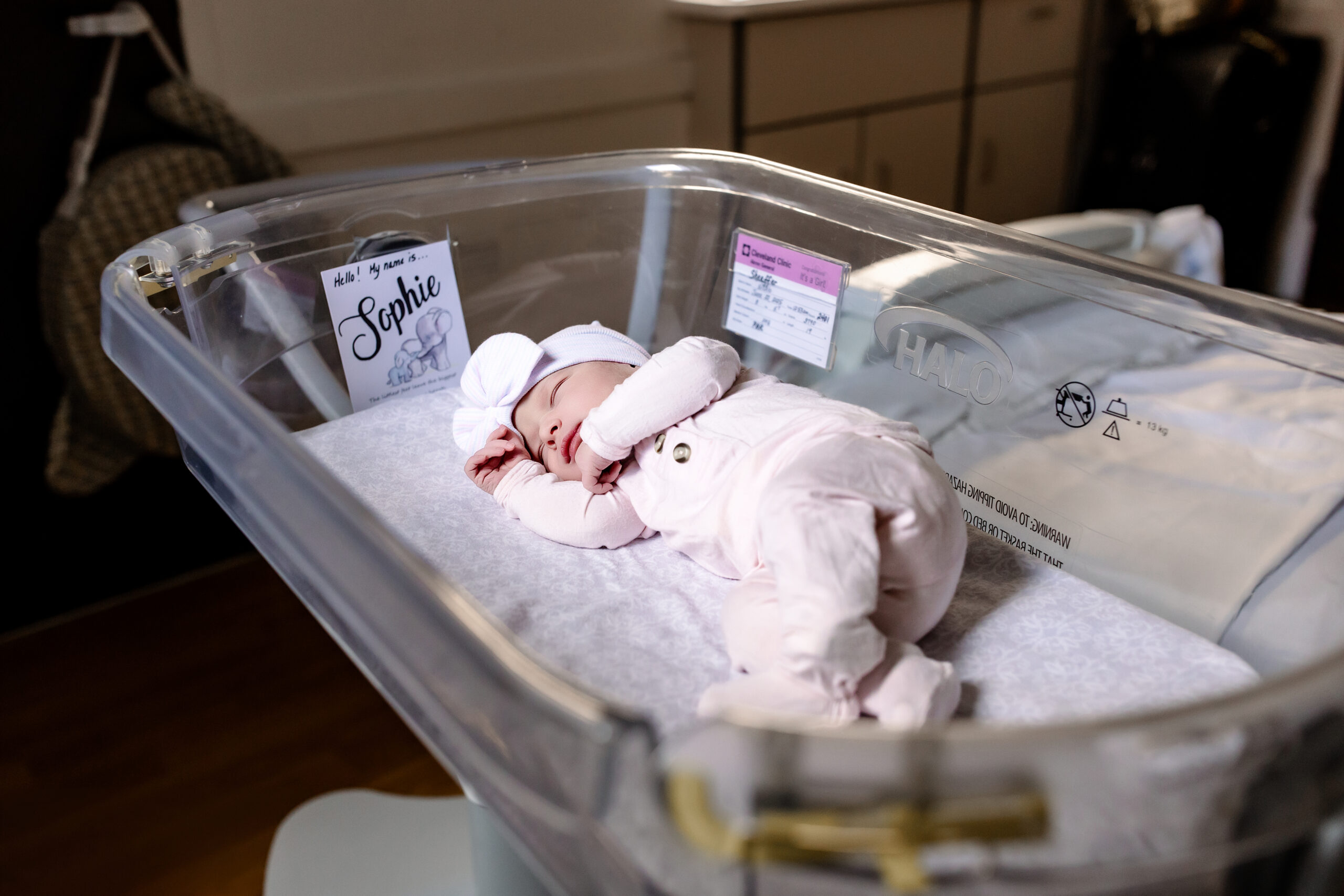 newborn baby girl in her bassinet at the hospital after a vagainal birth.