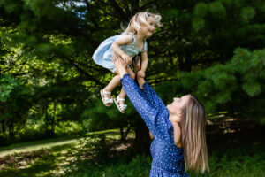 Daycare provider playing with little girl laughing
