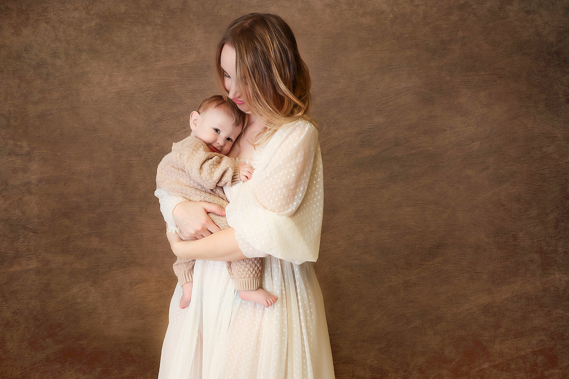 Close-up of mom cradling baby against her shoulder, eyes closed, showing deep connection and love.