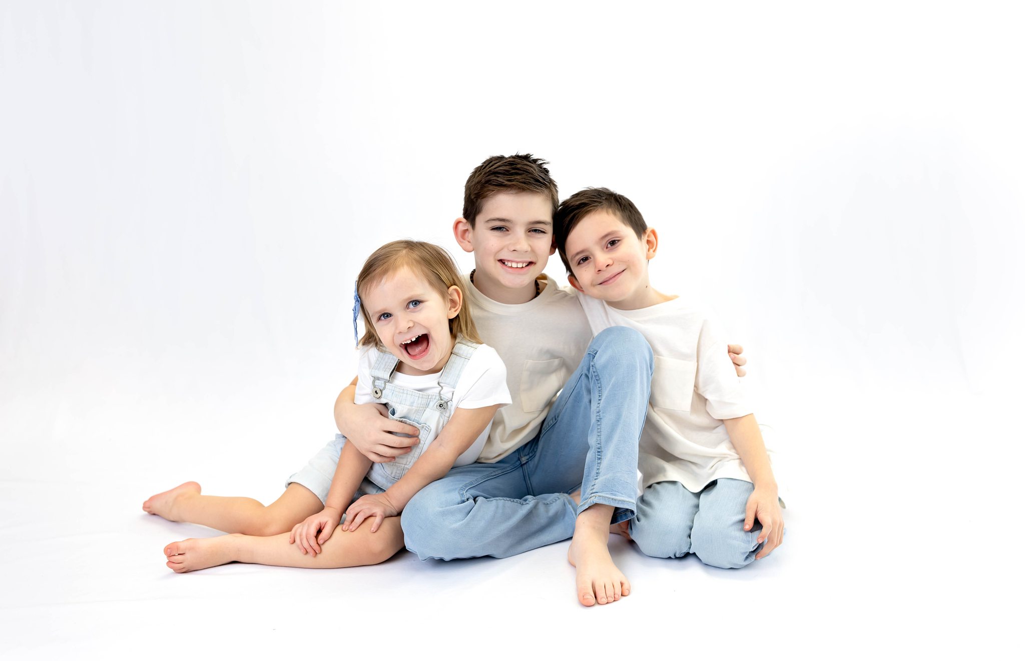 brothers and sister play together during their winter family photo session