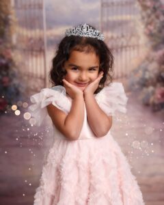 little girl pretends to be a princess at a dress up section at the cleveland childrens museum