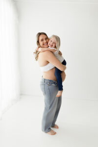 Medina Ohio maternity photographer capturing a mom to be holding her daughter