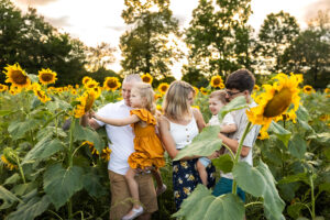Happy toddlers playing with their family in a sunflower farm while learning values from Christian toddler shows