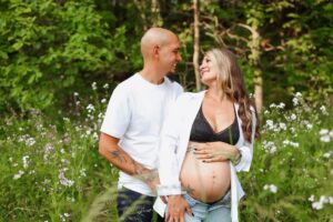 couple poses together in a field of spring flowers at allardale park medina 