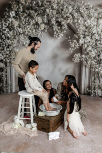Family participating in Easter foot washing mini session at Medina Ohio photography studio.
