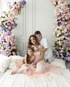 Mom cuddling her two children during a bright and airy Mother’s Day mini session in Northeast Ohio