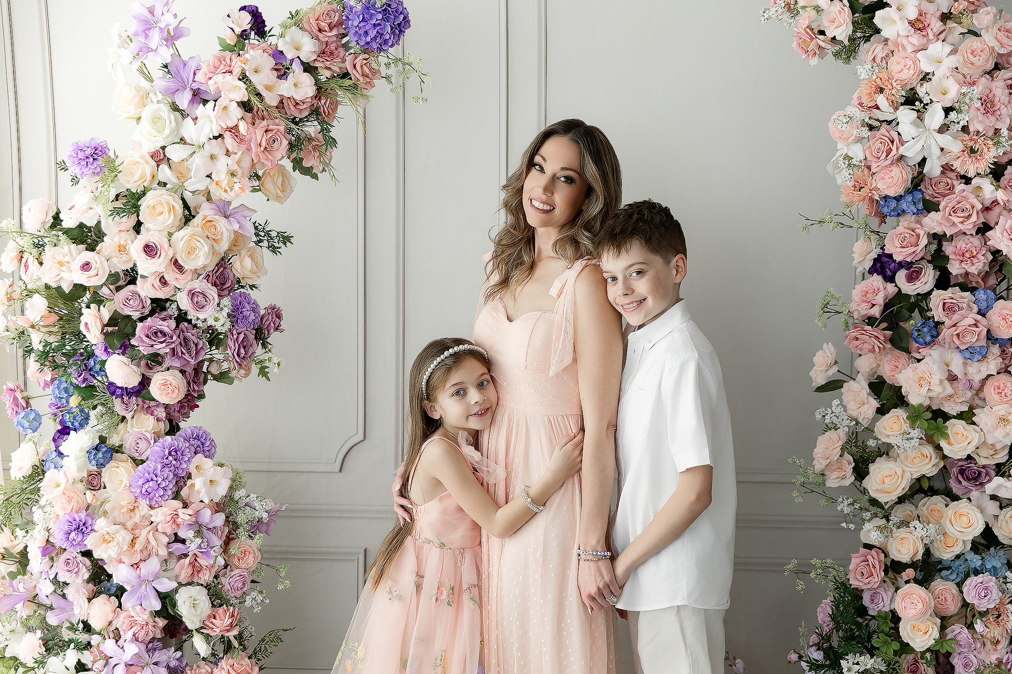 Family portrait from Mother’s Day mini session with mom standing and kids wrapped around her